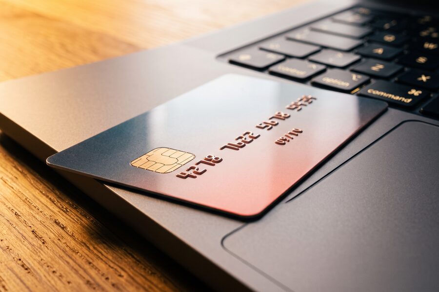 Bank card beside a laptop